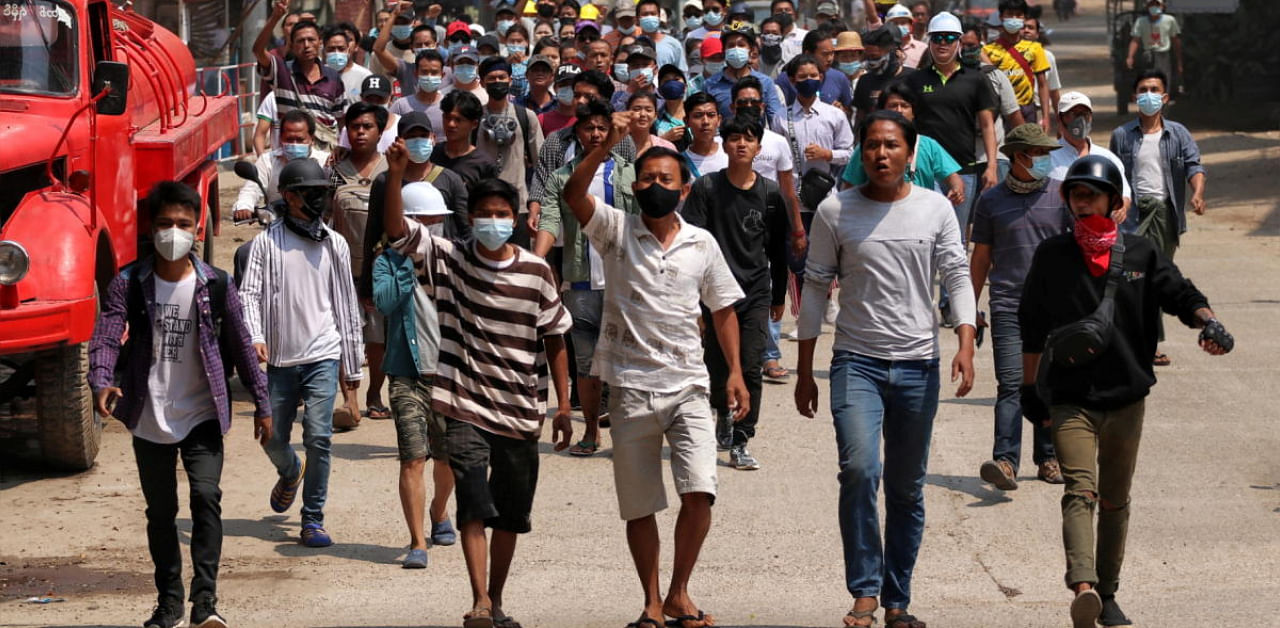 Anti-coup demonstrators gesture as they march in Nyaung-U, Myanmar. Credit: Reuters photo. 