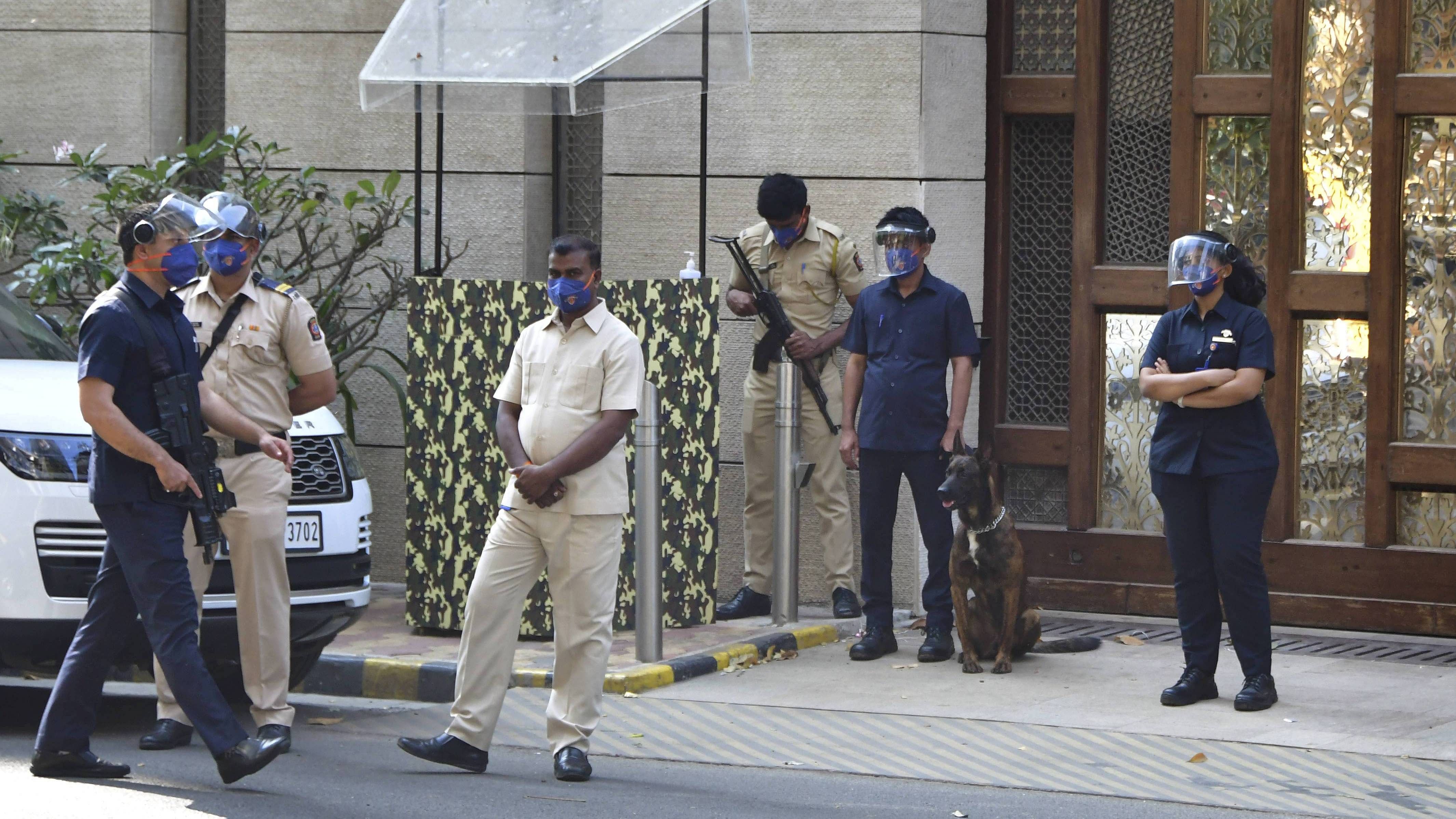 Police personnel guard outside industrialist Mukesh Ambani's residence Antilla, a day after explosives were found in an abandoned car in its vicinity, in Mumbai. Credit: PTI