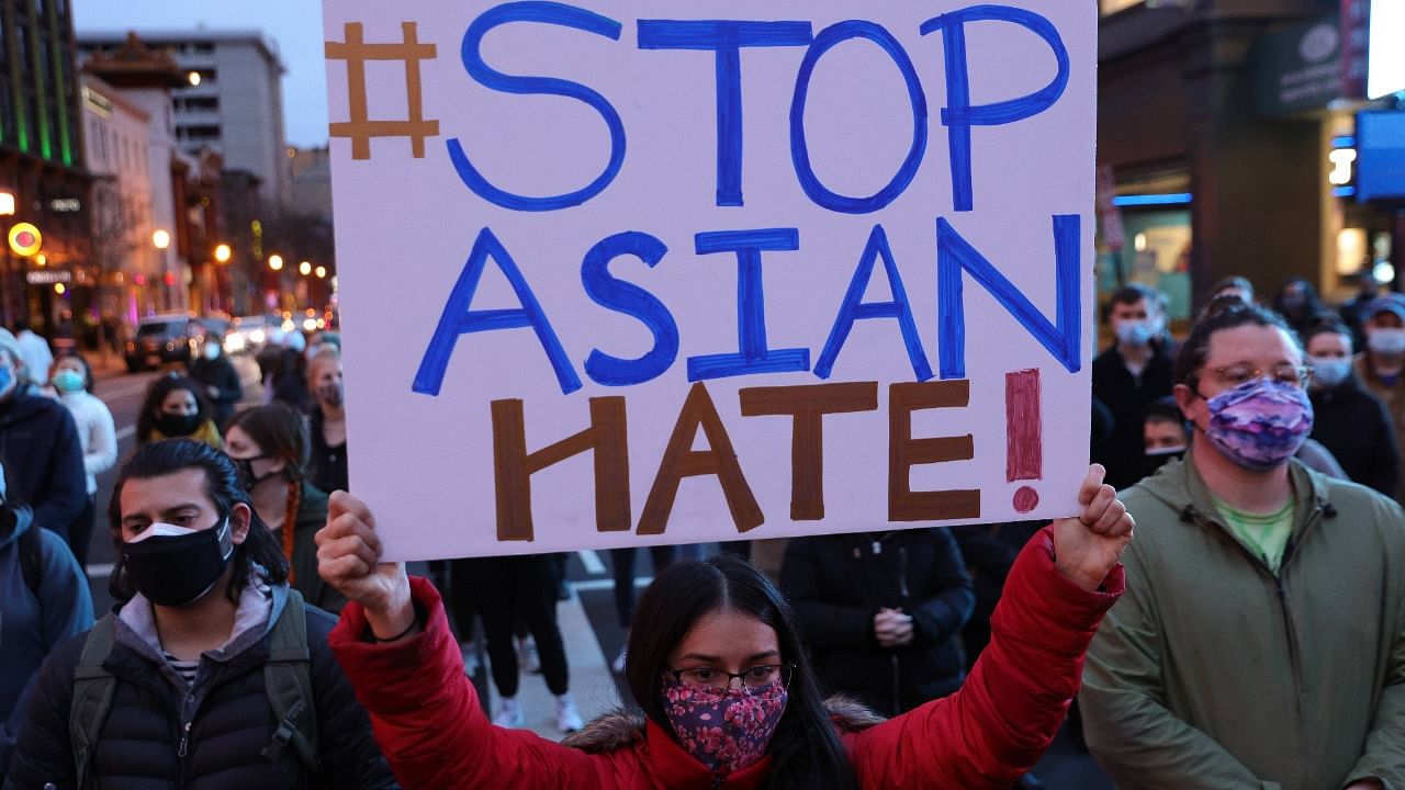 Activists participate in a vigil in response to the Atlanta spa shootings March 17, 2021 in the Chinatown area of Washington, DC. Credit: Alex Wong/Getty Images/AFP Photo