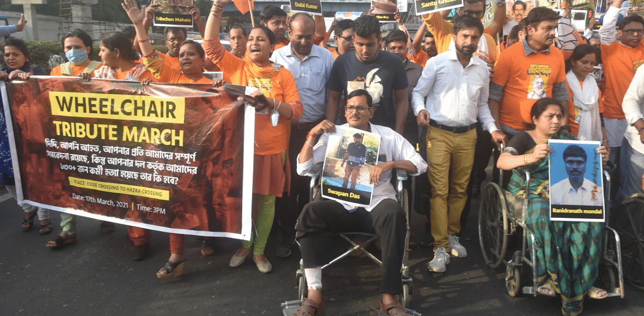  BJP activists take part in a 'Wheel Chair Tribute March' to honour 130+ BJP Karyakartas who were martyred since the 2018 Panchayat elections, in Kolkata, Wednesday. Credit: PTI Photo