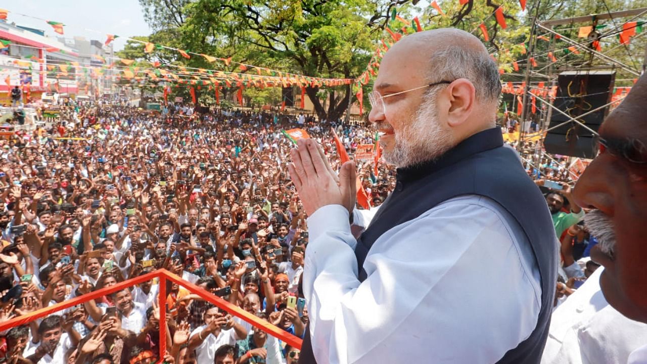 Home Minister and senior BJP leader Amit Shah greets supporters at Nagercoil, Kanyakumari. Credit: PTI Photo