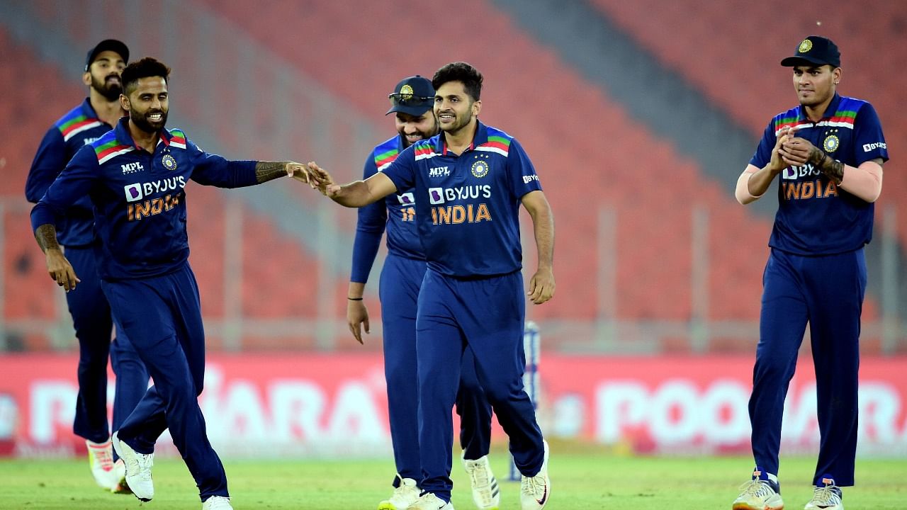 Indian bowler Shardul Thakur (C) with team celebrates the wicket of England batsman Eoin Morgan during the fourth Twenty20 match between India and England, at Narendra Modi Stadium in Ahmedabad. Credit: PTI Photo
