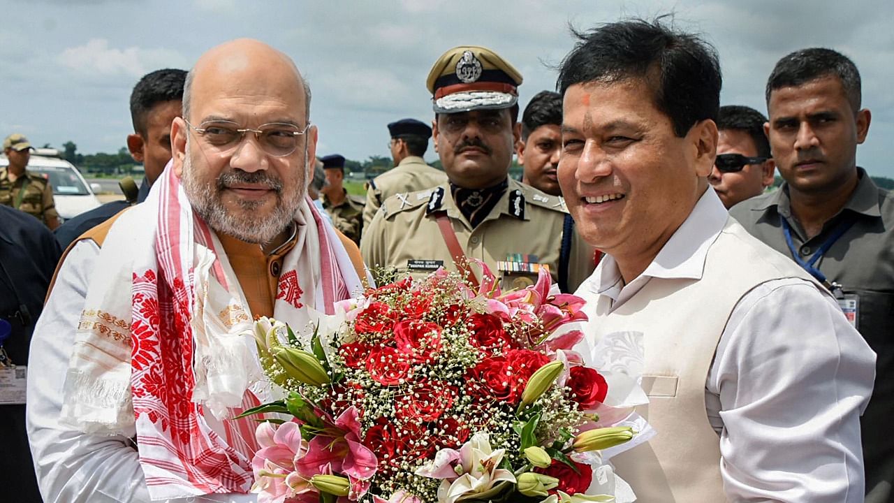 Union Home Minister Amit Shah is greeted byAssam Chief Minister Sarbananda Sonowal. Credit: PTI File Photo