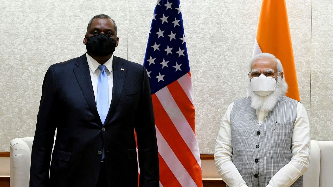 In this handout photograph taken on March 19, 2021 and released by the Indian Press Information Bureau (PIB) the US Defense Secretary Lloyd Austin (L) with Indian Prime Minister, Narendra Modi, prior to their meeting in New Delhi. Credit: AFP Photo