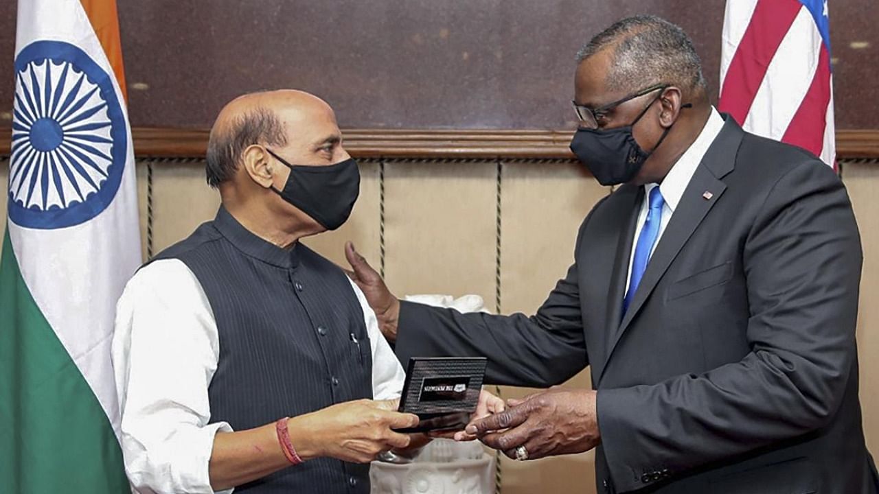 Defence Minister Rajnath Singh and his US counterpart Lloyd J Austin exchange mementos after bilateral talks, at Vigyan Bhawan in New Delhi. Credit: PTI.