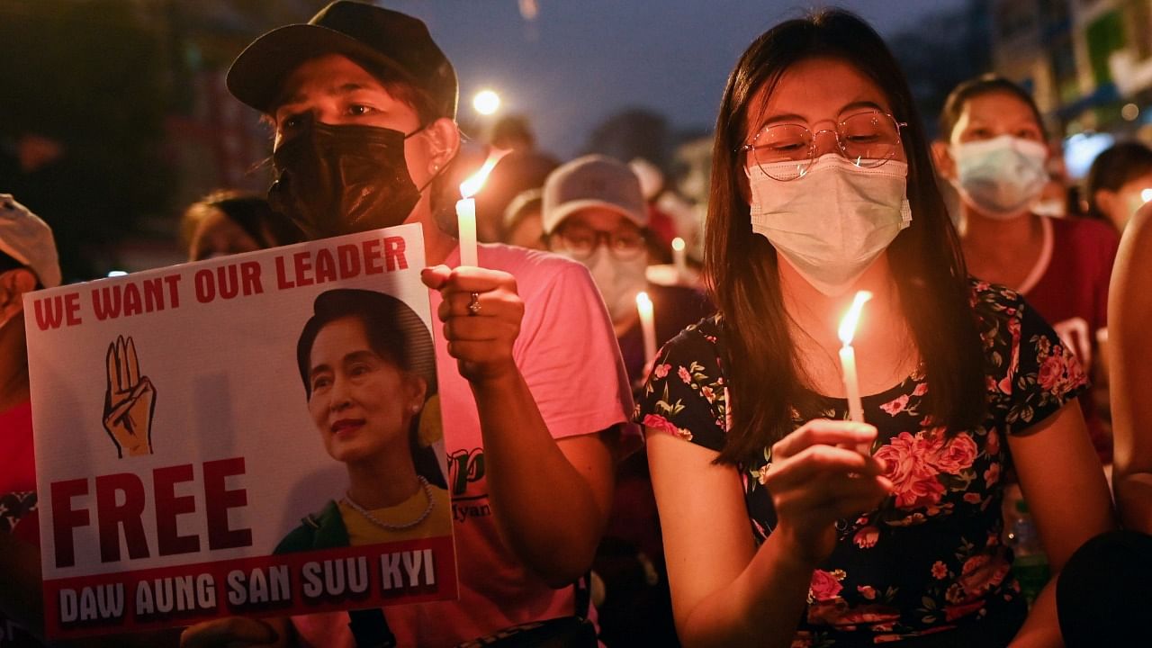 People hold candles as they take part in an anti-coup night protest in Yangon. Credit: Reuters