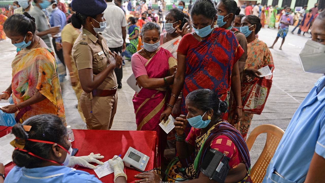 Front-line workers wait to get inoculated with the Covid-19 coronavirus vaccine at a mass vaccination camp held in Chennai on March 20, 2021. Credit: AFP Photo