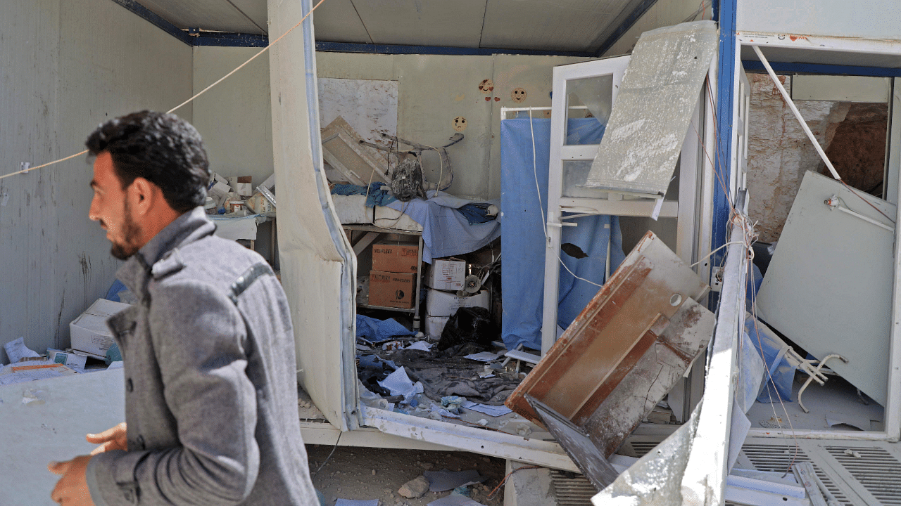 A man walks past a damaged room at the entrance of a field hospital in the the village of Atareb in the northern Syrian province of Aleppo. Credit: AFP Photo