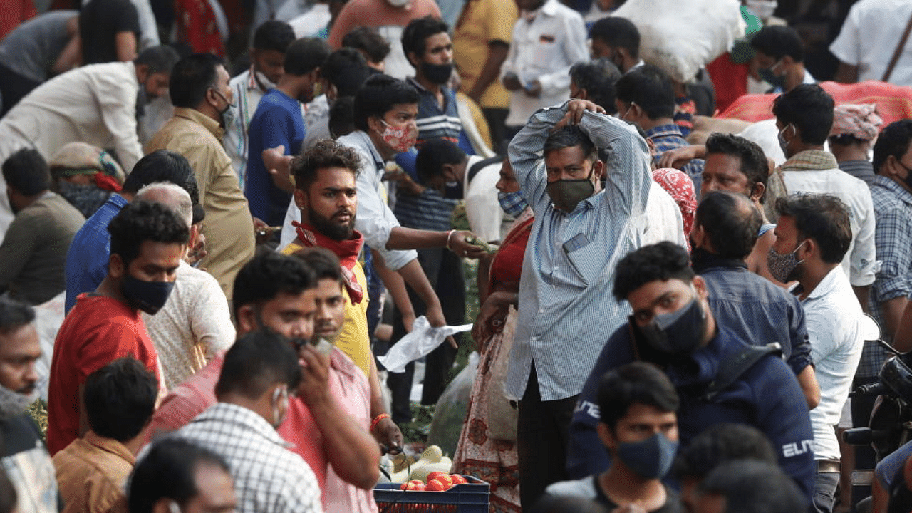 People are seen at a crowded market amidst the spread of the coronavirus disease in Mumbai. Credit: Reuters Photo