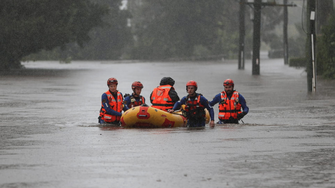 A State Emergency Service rescue team uses an inflatable raft to bring a local resident to safety from a flooded home as the state of New South Wales experiences widespread flooding and severe weather, in Sydney, Australia, March 21, 2021. Credit: AFP Photo