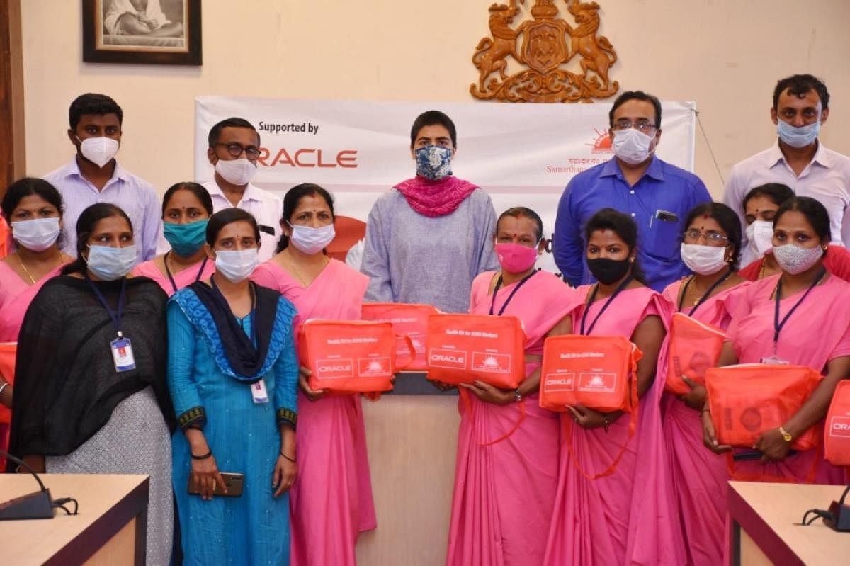 Deputy Commissioner Charulata Somal handed over health and hygiene kits to Asha workers, at her office hall in Madikeri, on Monday.