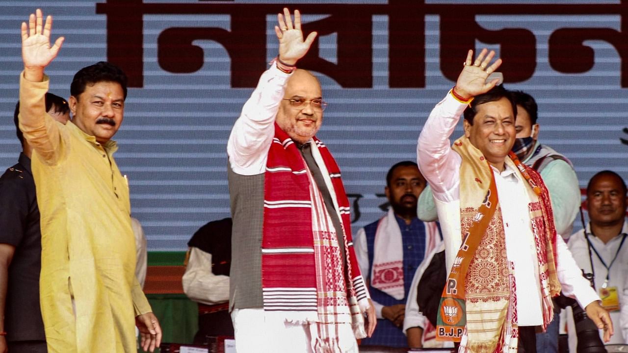 Union Home Minister Amit Shah (C) with Assam CM Sarbananda Sonowal (R) and BJP State President Ranjit Kumar Dass during an election rally in Majuli. Credit: PTI Photo