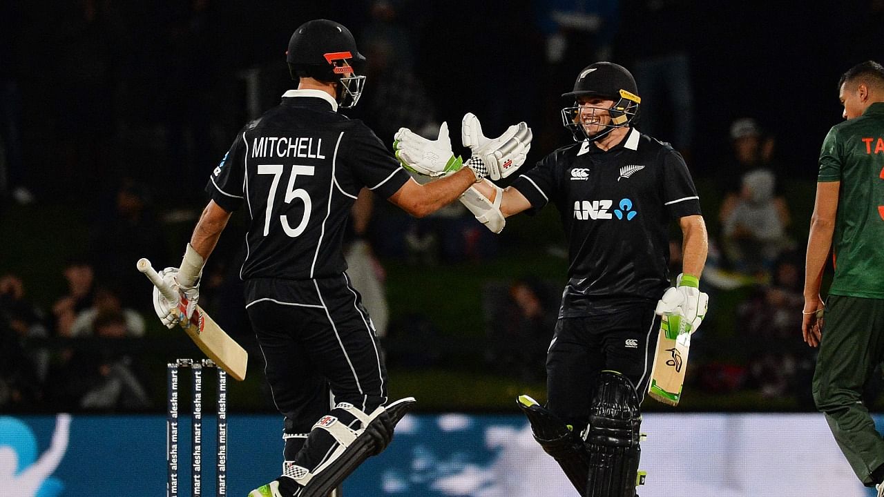 New Zealand's Tom Latham (R) is congratulated by teammate Daryl Mitchell (L) after scoring a century during the second ODI cricket match between New Zealand and Bangladesh at the Hagley Oval in Christchurch. Credit: AFP Photo