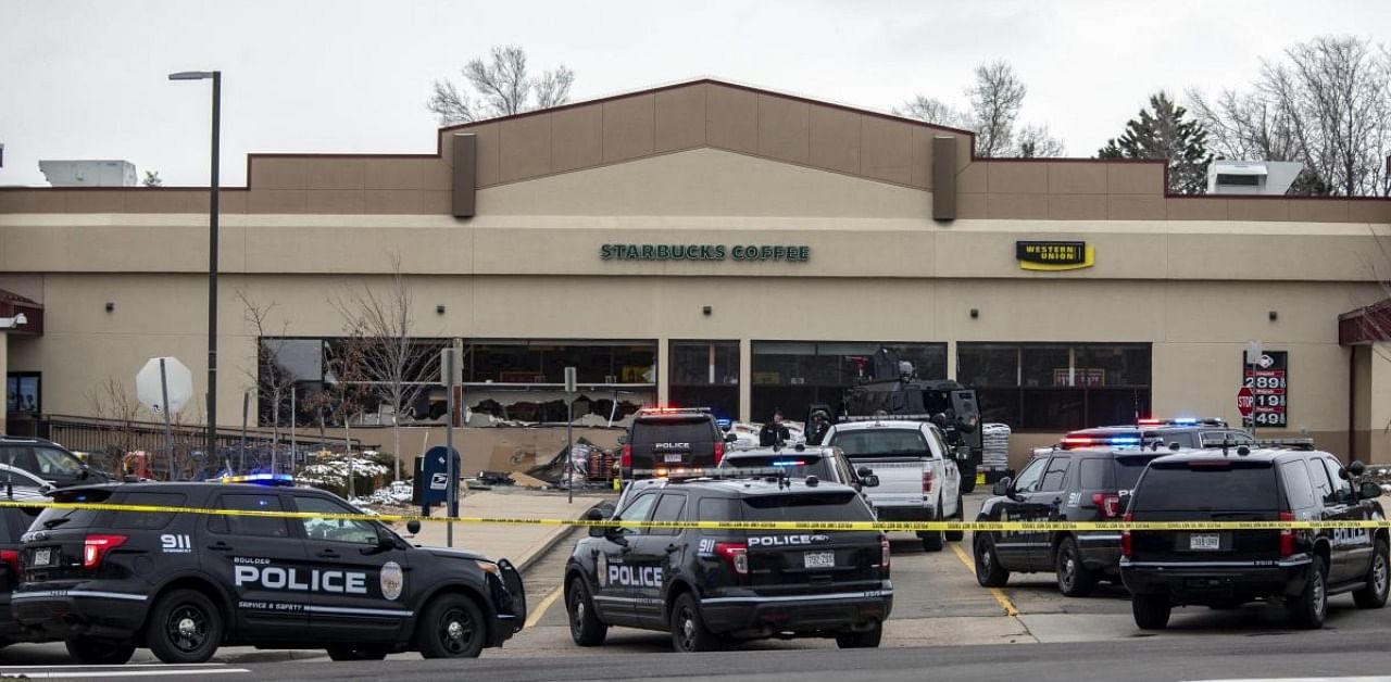 Shattered windows are shown in front of a King Soopers grocery store where a gunman opened fire in Boulder, Colorado. Credit: AFP Photo