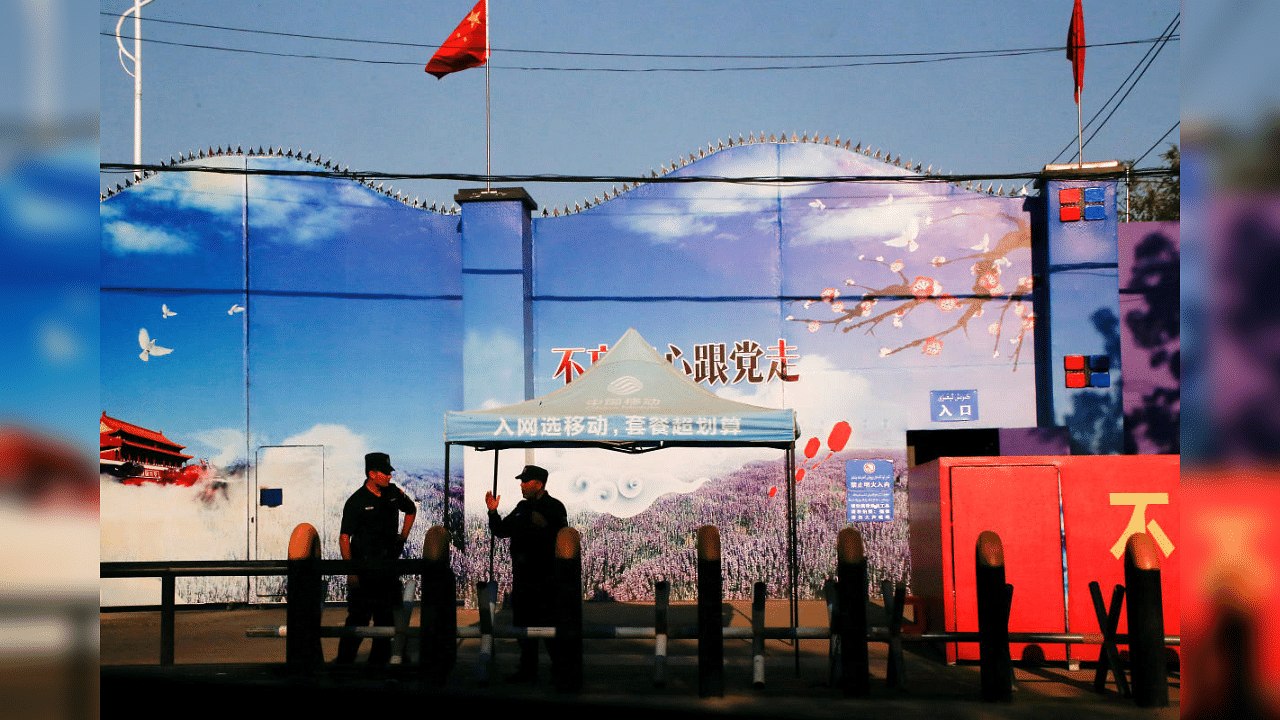 Security guards stand at the gates of what is officially known as a vocational skills education centre in Huocheng County in Xinjiang Uighur Autonomous Region, China. Credit: Reuters File photo