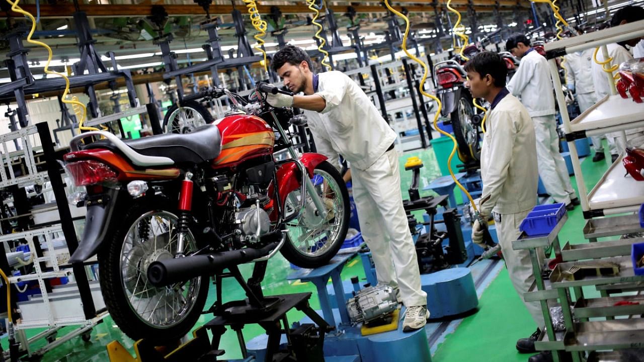 Employees work on an assembly line of a Hero MotoCorp plant in Neemrana. Credit: Reuters.