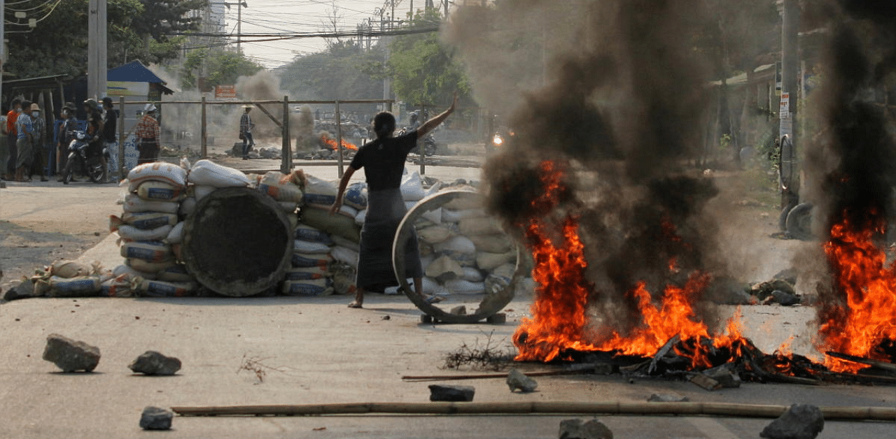 A demonstrator gestures near a barricade during a protest against the military coup in Mandalay, Myanmar. Credit: Reuters photo. 