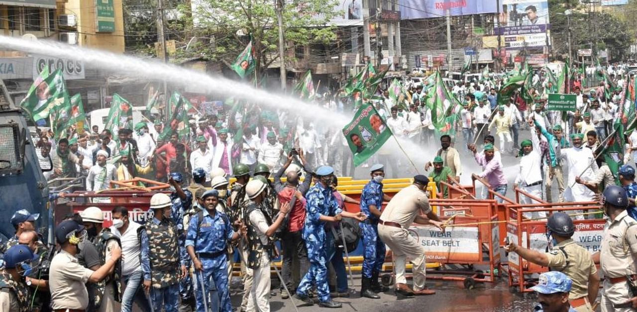  Police use water cannon on Rashtriya Janata Dal supporters during their Vidhan Sabha protest march over issues of unemployment, inflation, law and order and farm laws, in Patna, Tuesday, March 23, 2021. 