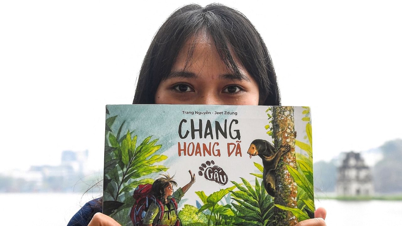 Trang Nguyen, founder of local conservation group WildAct, posing with her book along in Hanoi. Credit: AFP Photo
