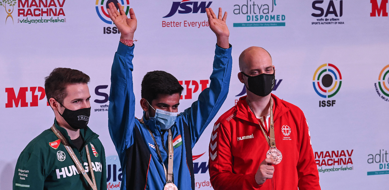 Gold medalist India's Aishwary Pratap Singh (C), silver medalist Hungry's Istvan Peni (R) and bronze medalist Denmark's Steffen Olsen. Credit: AFP Photo
