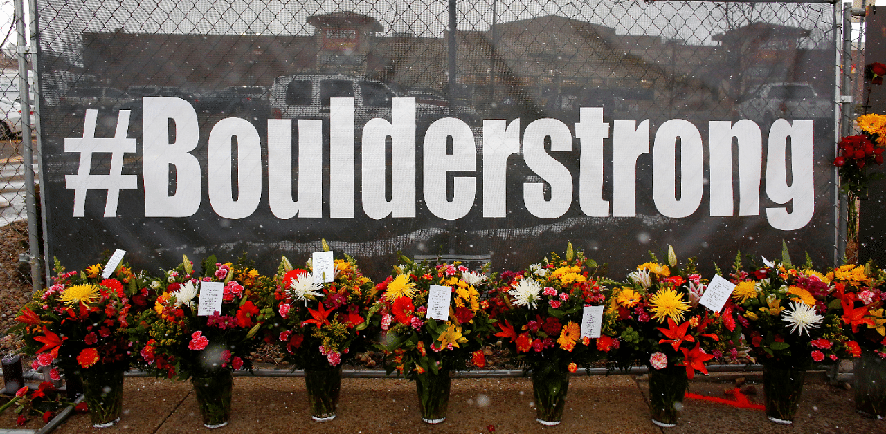 People leave flowers at the site of a mass shooting at King Soopers grocery store in Boulder. Credit: Reuters Photo