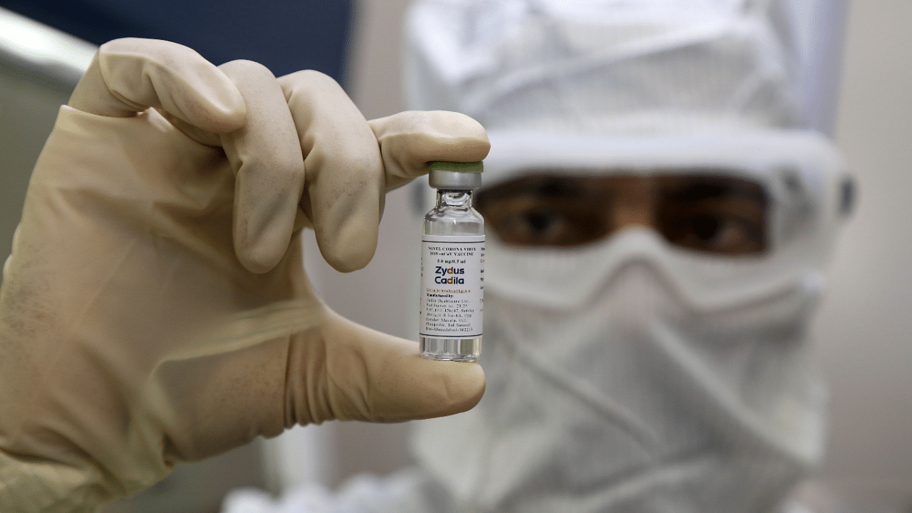 A pharmaceutics worker shows a shot of a vaccine developed by Zydus Cadila to treat the Covid-19. Credit: AFP Photo