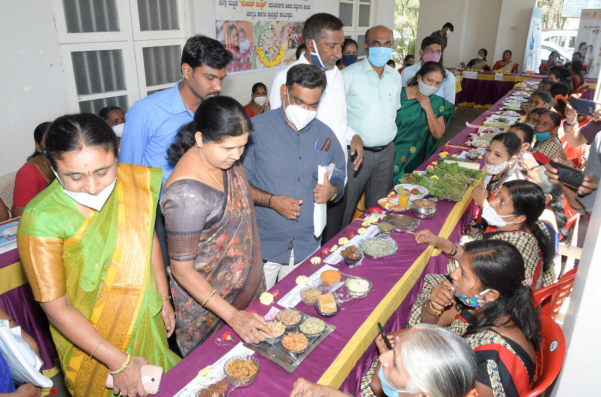 Zilla Panchayat president B C Parimala Shyam and vice-president Gowramma Somashekar take a look on traditional food on display, as part of Central Government’s 'Poshan Pakhwada' campaign on nutrition food, at ZP in Mysuru on Wednesday. DH PHOTO