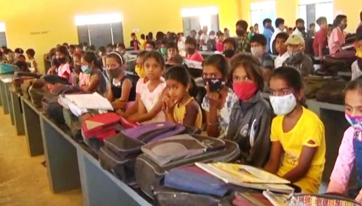 Students seated at a community hall in Chikkadoddi village near Koppa, and classes conducted in Mandya district. DH PHOTO