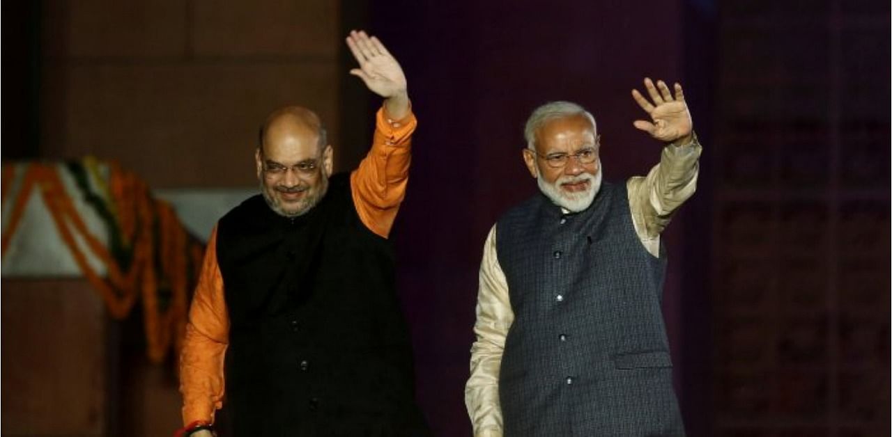 Prime Minister Narendra Modi (R) and Home Minister Amit Shah (L). Credit: Reuters Photo