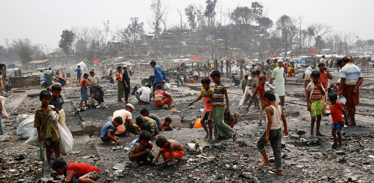 Rohingya refugees search for valuable materials, such as gold, in the ashes after a massive fire broke out two days ago and destroyed thousands of shelters in Cox's Bazar. Credit: Reuters Photo