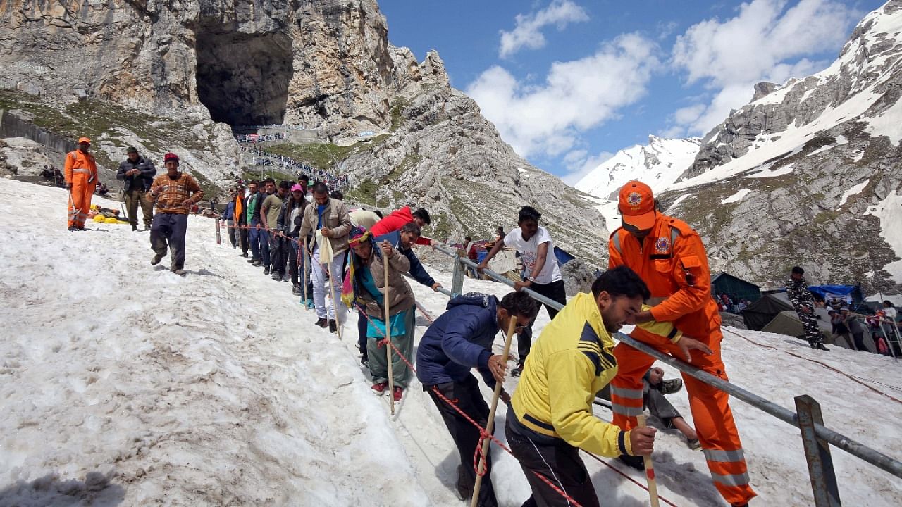 Hindu pilgrims leave the holy cave of Lord Shiva after worshipping in Amarnath, southeast of Srinagar, July 2, 2019. Credit: Reuters File Photo