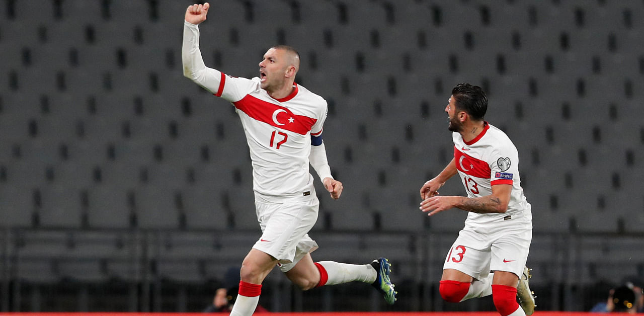 Turkey's forward Burak Yilmaz (L) celebrates with Turkey's defender Umut Meras after scoring his team's fourth goal. Credit: AFP Photo