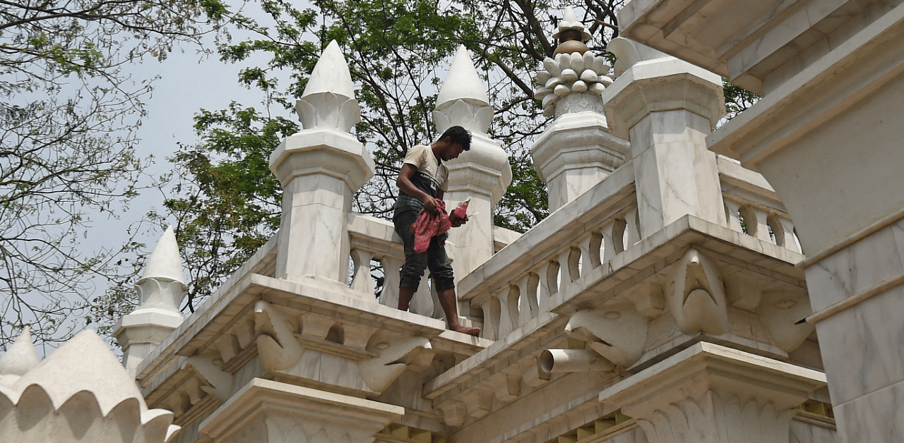 A worker cleans the facade of the Harichand Thakur temple in Orakandi, some 120 kms from Dhaka on March 19, 2021 ahead of Indian Prime Minister Narendra Modi's visit. Credit: AFP Photo