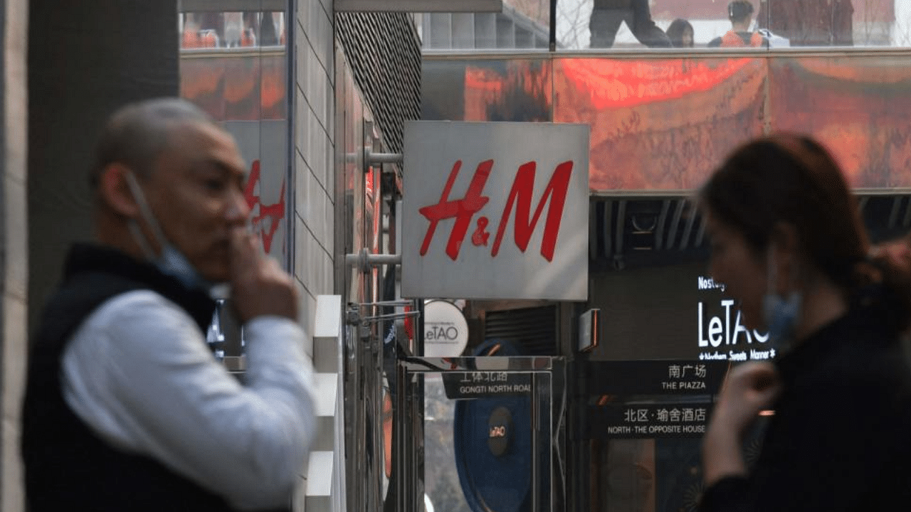 People stand outside a store of Swedish clothing giant H&M in Beijing on March 25, 2021. Credit: AFP Photo
