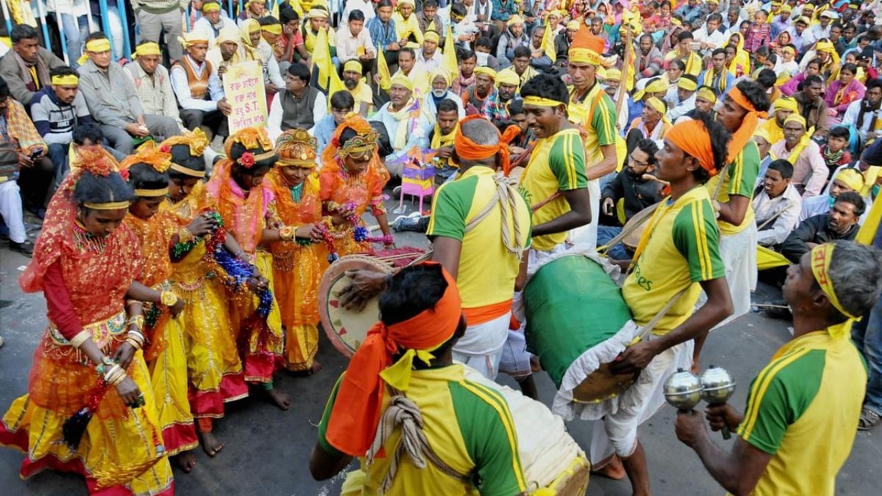 Tribals artists of the 'Kurmi' community participate in a rally, in Kolkata. Credit: PTI file photo.