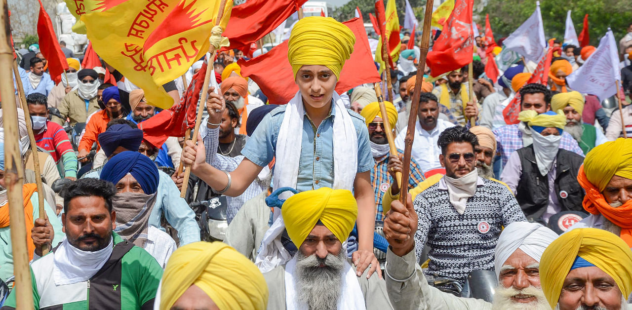 Farmers take out a march to commemorate the martyrdom day of freedom fighters Bhagat Singh, Rajguru and Sukhdev, during their ongoing agitation against new farm laws. Credit: PTI Photo