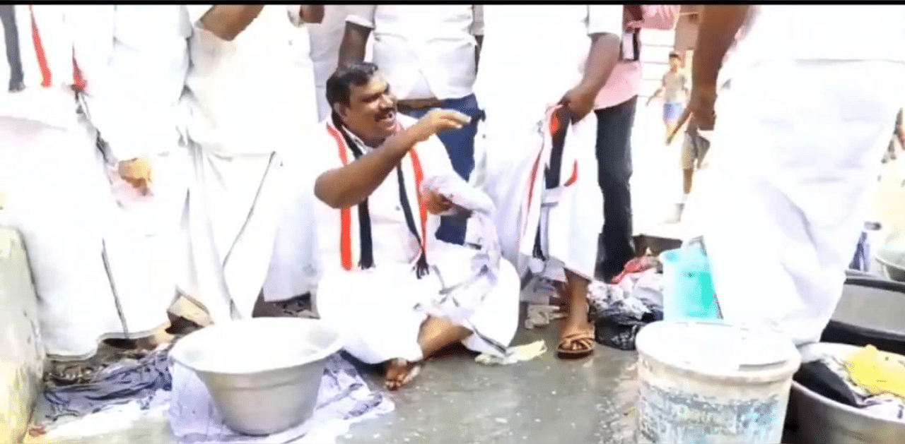 AIADMK candidate Thanga Kathiravan washing clothes. Credit: Screengrab.