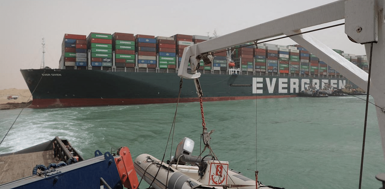 Egyptian tug boats trying to free Taiwan-owned cargo MV Ever Given (Evergreen), a 400-metre- (1,300-foot-)long and 59-metre wide vessel. Credit: AFP Photo