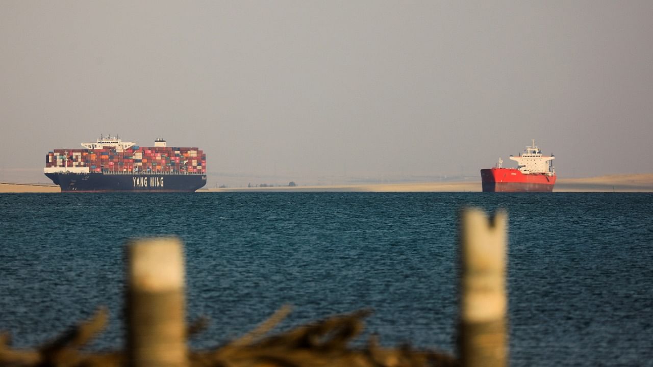 A Yang Ming cargo ship and another ship are anchored outside the Suez Canal, where a container ship ran aground and blocked traffic, in Ismailia, Egypt March 25, 2021. Credit: Reuters Photo