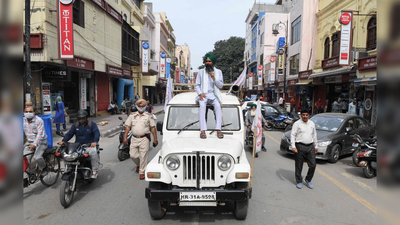 A farmer sits on a jeep as he announces a general strike over agriculture reforms in Amritsar on March 25, 2021. Credit: AFP Photo