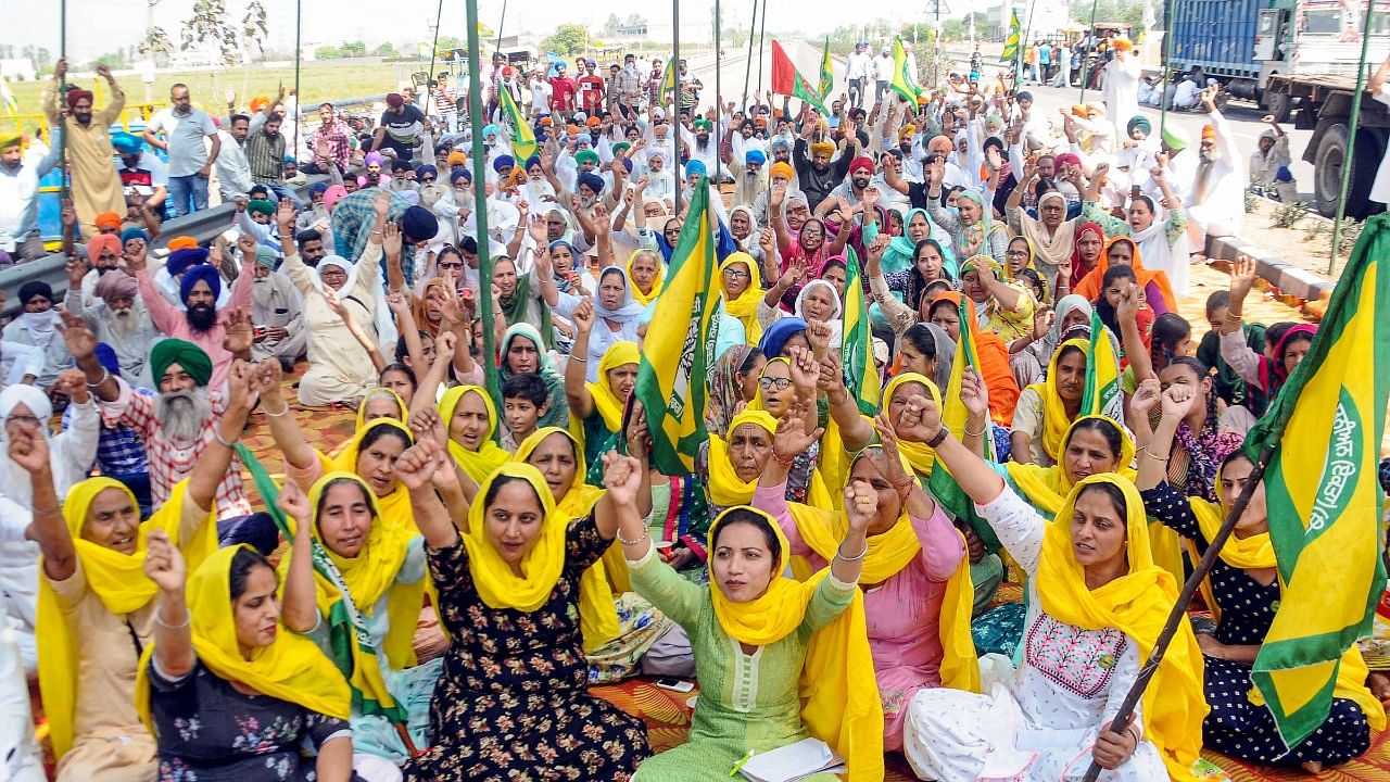 Farmers shout slogans during 'Bharat Bandh', a protest against the Centre's three new farm laws, in Patiala. Credit: PTI Photo
