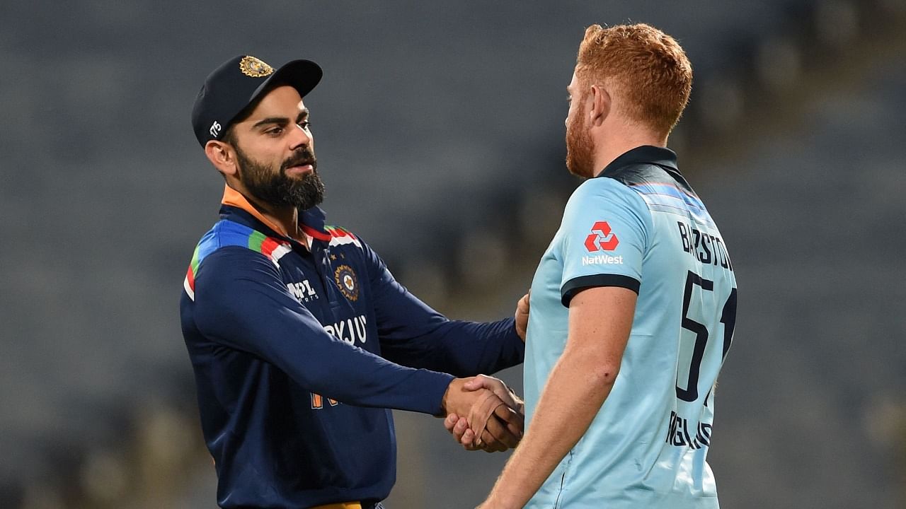 India's captain Virat Kohli (L) shakes hands with England's Jonny Bairstow after the second ODI between India and England in Pune. Credit: AFP Photo
