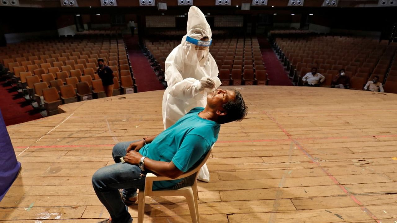 A health worker conducts a rapid antigen test for Covid-19 in Ahmedabad. Credit: Reuters Photo