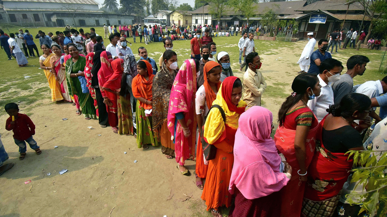 Voters queue up at a polling station during the first phase of polling in Nagaon district in Assam. Credit: PTI Photo
