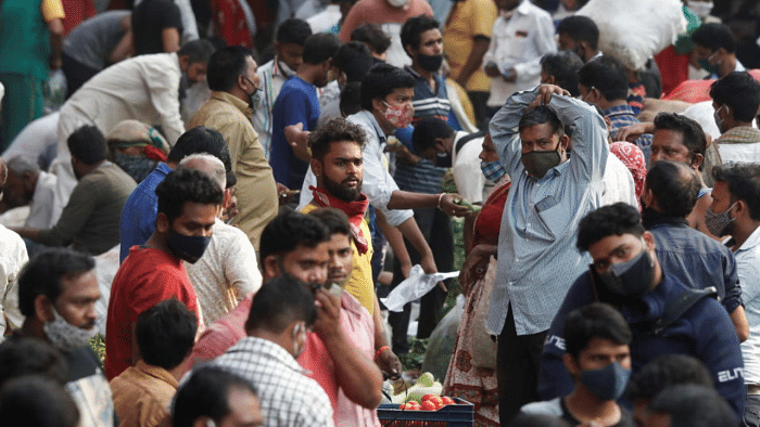 People are seen at a crowded market amidst the spread of the coronavirus disease in Mumbai. Credit: Reuters Photo