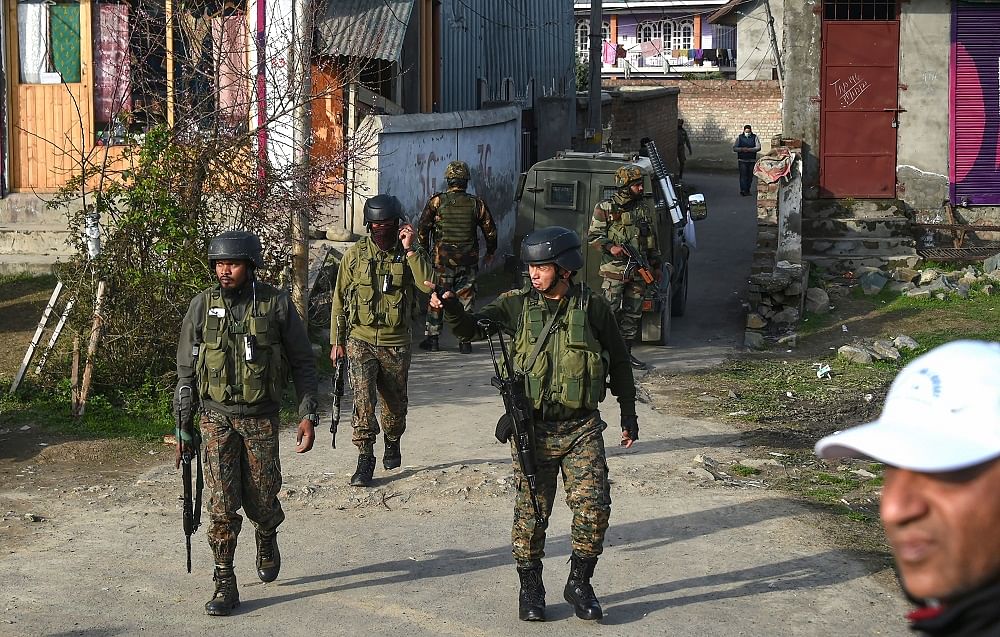 Security personnel during a search operation after a militant attack, at Lawaypora on the outskirts of Srinagar. Credit: PTI Photo