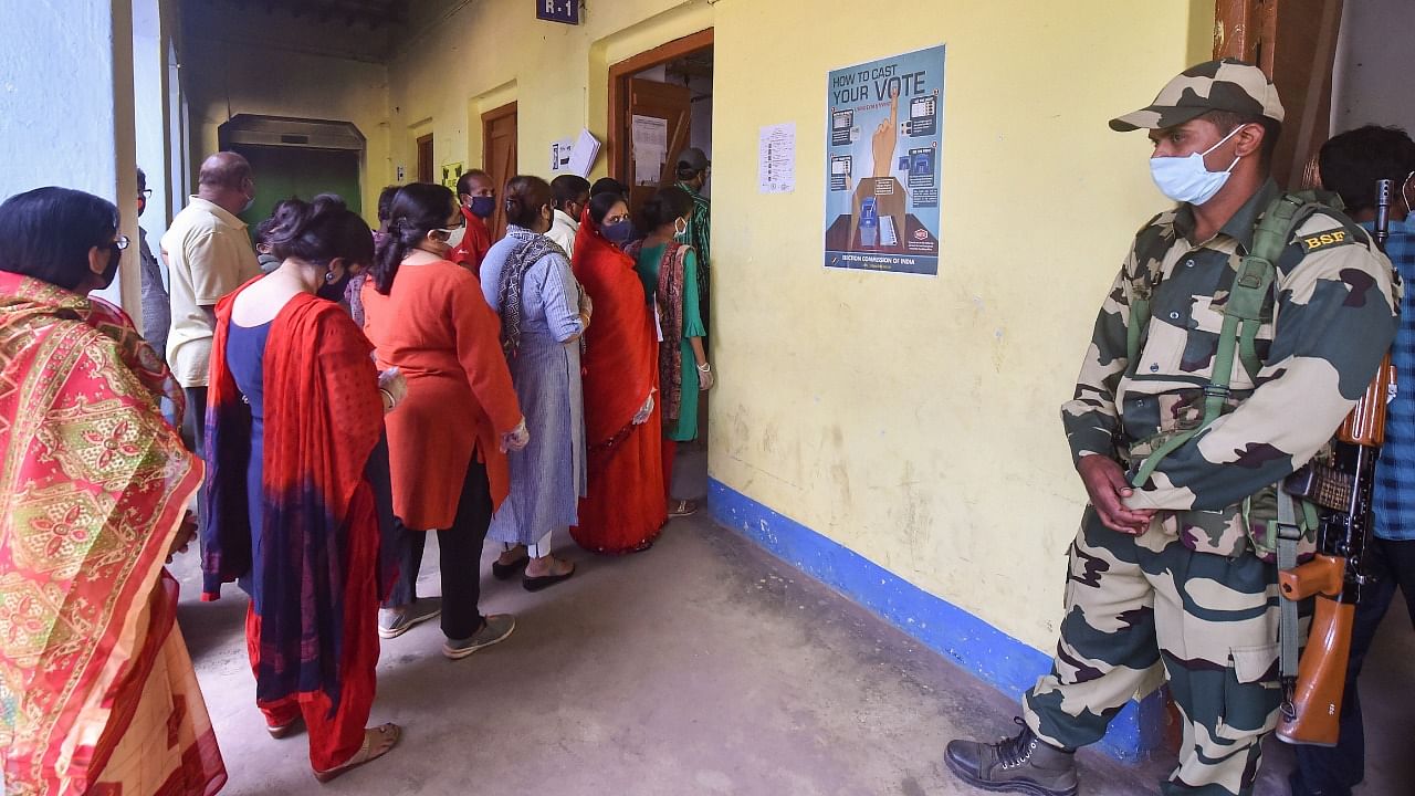 Voters wait at a polling booth to cast their votes during the first phase of State Assembly polls, in Midnapore, Saturday, March 27, 2021. Credit: PTI Photo