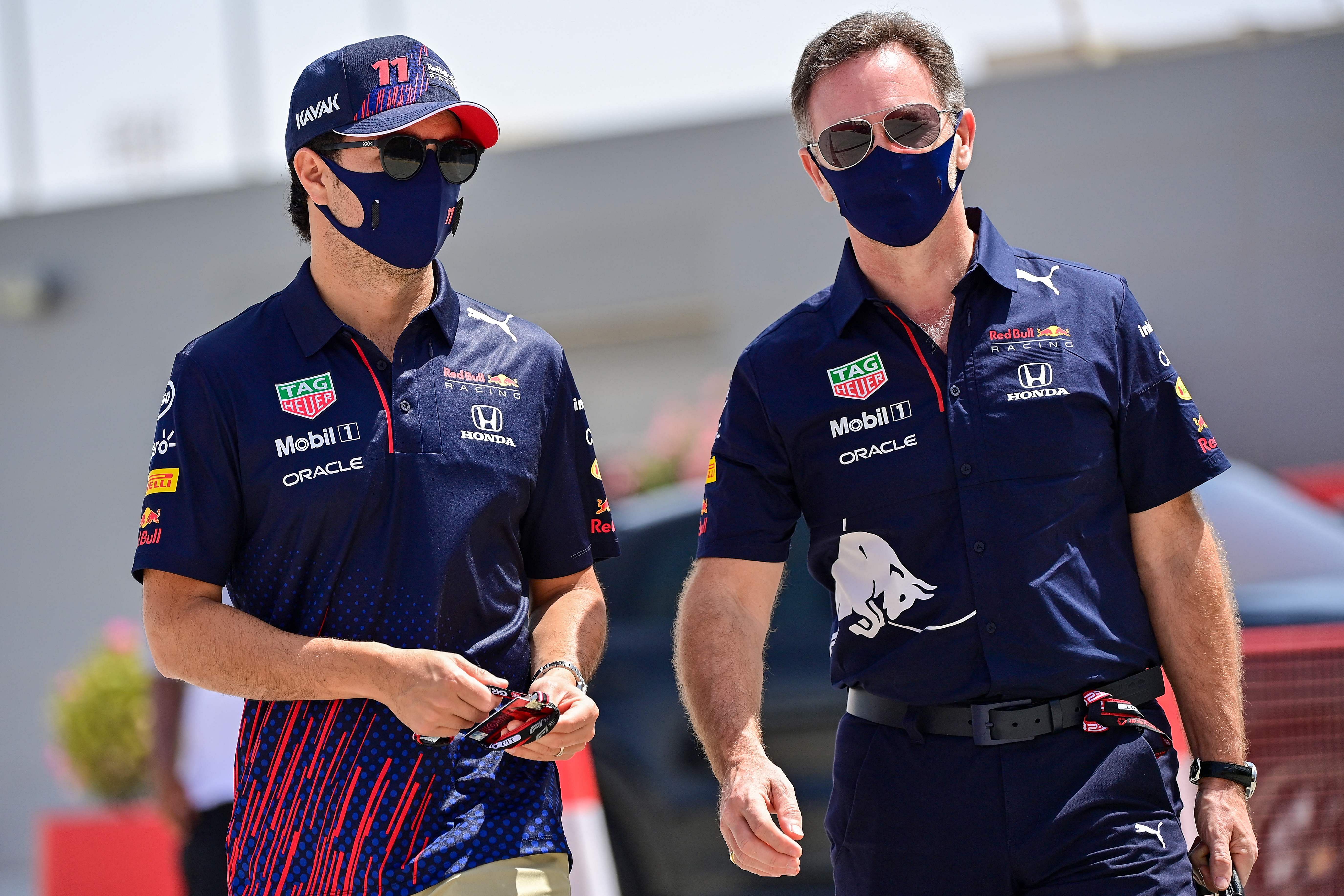 Red Bull's Mexican driver Sergio Perez (L) and Red Bull Racing's team principal Christian Horner arrive fot the third practice session ahead of the Bahrain Formula One Grand Prix. Credit: AFP Photo