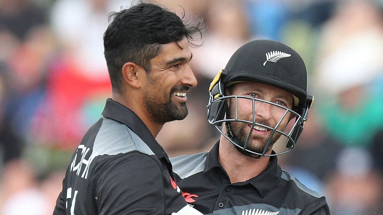 New Zealand's Ish Sodhi (L) is congratulated by wicketkeeper Devon Conway after taking a wicket. Credit: AFP Photo