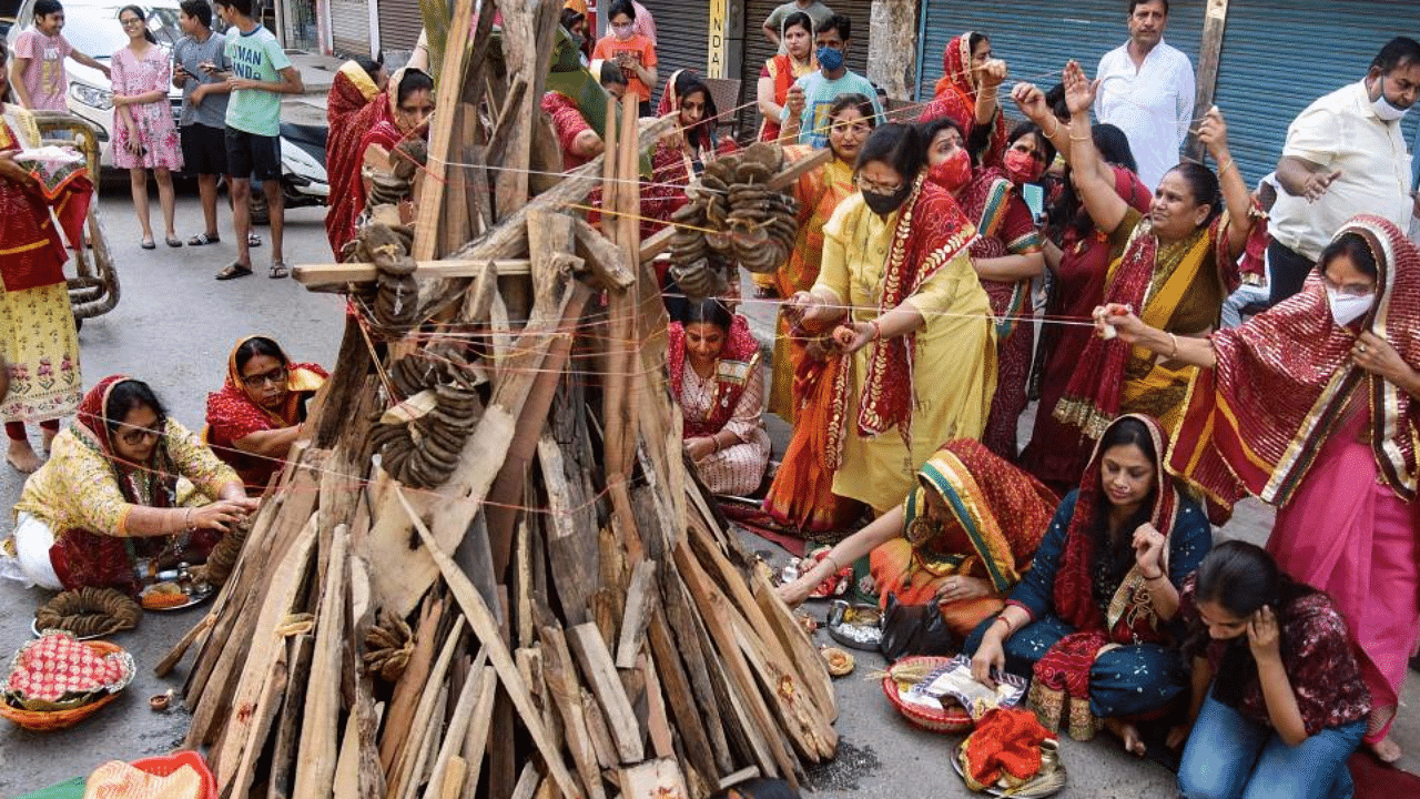 Women perform rituals during 'Holika Dahan' on the eve of Holi festival, in Patna, Sunday, March. 28, 2021. Credit: PTI Photo